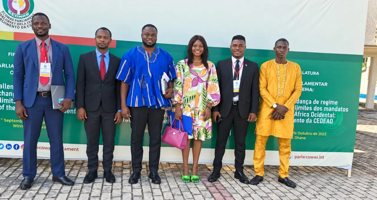 Group beside an ECOWAS Parliament event banner